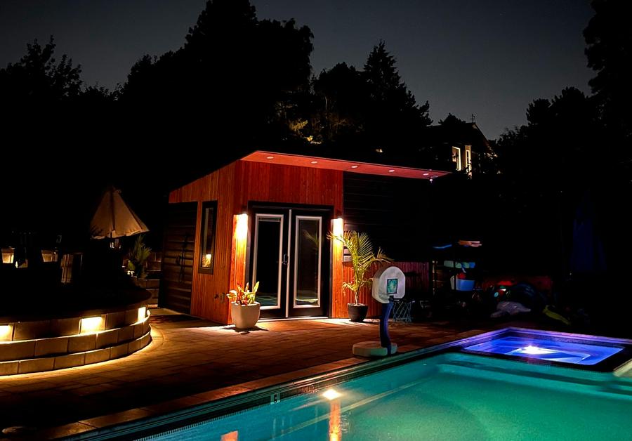 The pool and pool house lit up at night